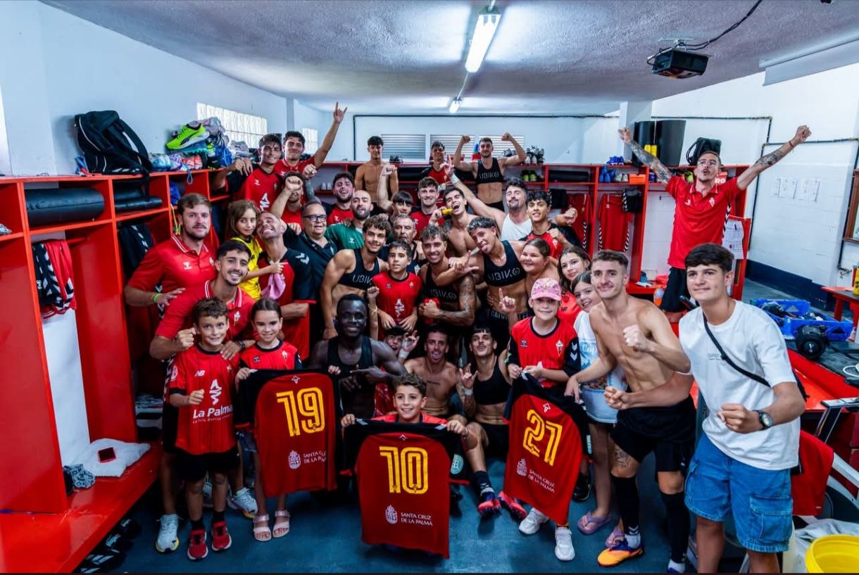Plantilla, cuerpo técnico y jóvenes aficionados del CD Mensajero celebrando la victoria ante el Tenerife C